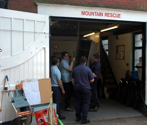 Team members moving equipment etc. out of Overdale.