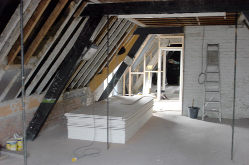 The view from one end of the room to the office area and entrance.