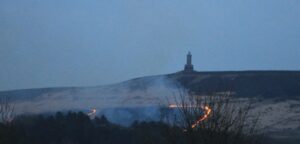Photo taken from Abbey Village showing the flame front beneath Jubilee (Darwen) Tower.