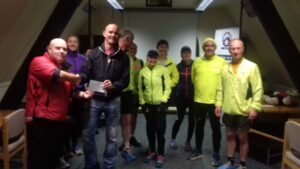 Team leader receiving a cheque for £300 from members of Lostock Athletics Club.