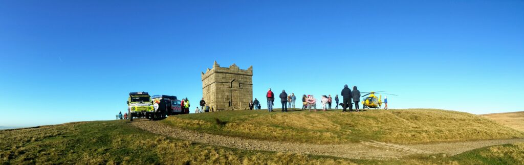 Team vehicles and the North West Air Ambulance on the summit of Rivington Pike